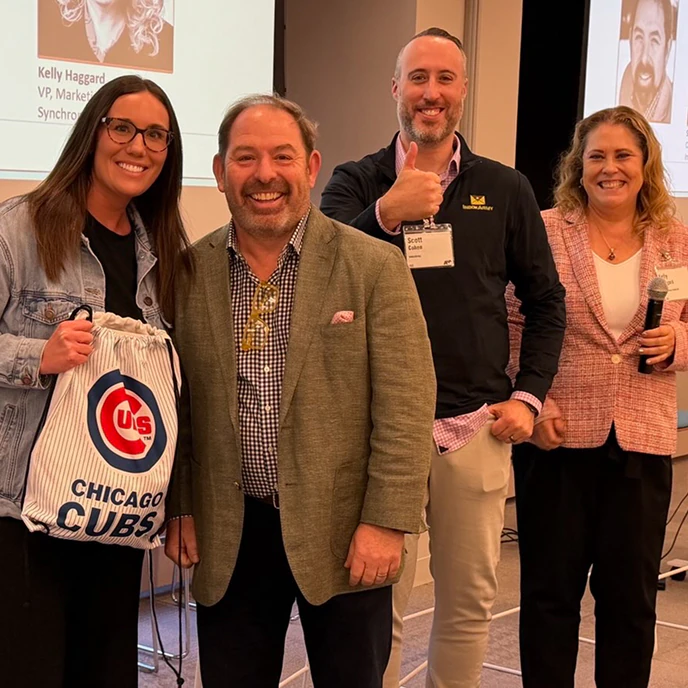 Four people smiling together at an email marketing event